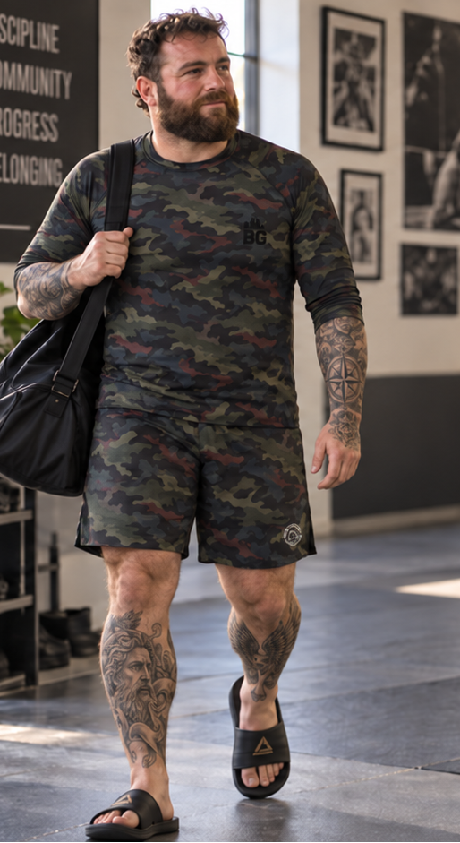 Grappler wearing Midnight Hunt camo no-gi training shorts with matching rash guard